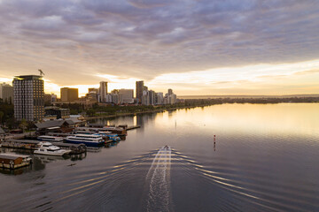 Fototapeta premium Golden sunrise over the Perth city center. A beautiful light catching the buildings as people start their day. 