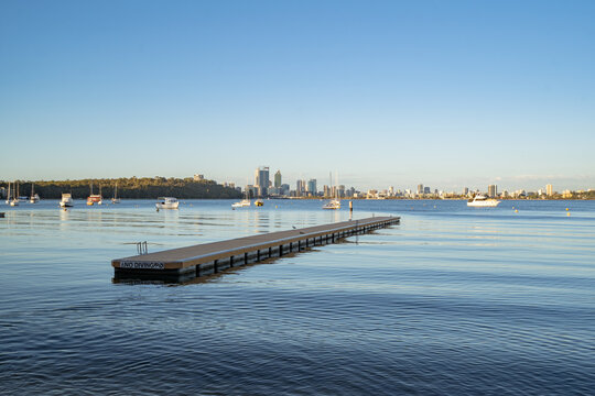 A calm morning at Matilda Bay Reserve, Perth. The city can be seen in the background with boats in the bay. 