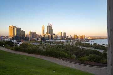 Fototapeta na wymiar Golden sunrise over the Perth city center. A beautiful light catching the buildings as people start their day. 
