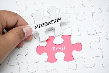 Missing puzzle with a word Mitigation Plan. Business concept puzzle piece. Business and finance concept.