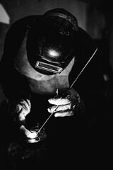 Welder working at the factory made metal