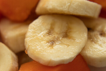 Macro photography to a fresh sliced banana and papaya pieces