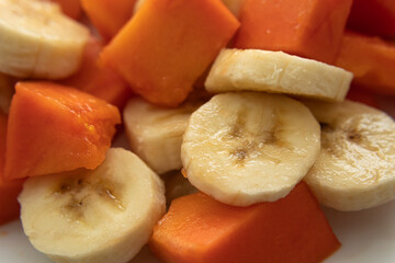 Macro photography to a fresh sliced banana and papaya pieces