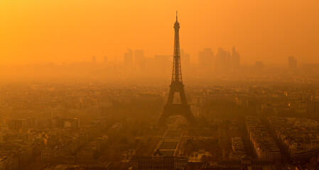 Eiffel Tower at the distant, in a foggy sunset. Paris, France