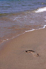 Footprint on the sand at the beach.