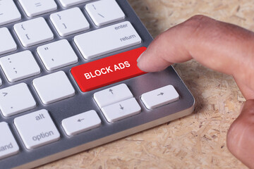 Man pressed keyboard button with BLOCK ADS word