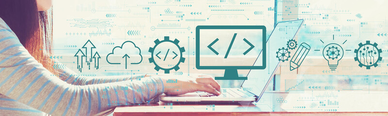 Web development concept with woman working on a laptop in brightly lit room