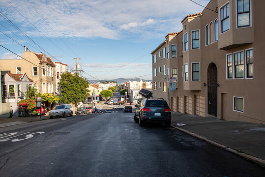 Typical street in San Francisco, California with victorian style houses and cars parked alongside in a sunny December morning © auseklis