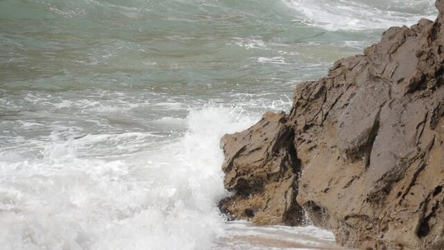 Waves beating against rocks during storm