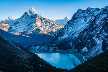 Grand view of Cholatse glacial lake and Ama Dablam mountain peak during sunset. View from Dzongla on the way to Cho La pass in Everest region of Nepal enroute to Everest Base Camp.