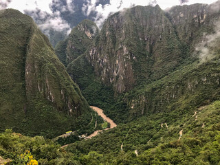 Brown River in the Middle of the Green Mountains, near to The Majestic Machu Picchu, the Inca city Located High in the Andes Mountains in Cuzco / Peru