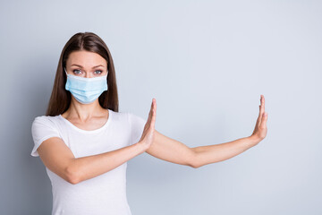 Photo of pretty serious lady keep social distance avoid people contacting hospital examination raise arms side copyspace empty space wear protect face mask isolated grey color background