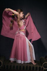 A little girl dressed as an belly dancer