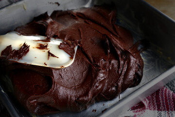 Chocolate brownies batter on a baking pan