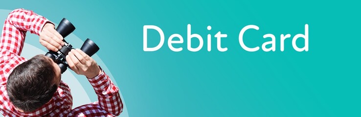 Naklejka premium Debit Card. Businessman (man) looks through binoculars. Birds eye view. Focus on text. Blue Background. Business, Finance, Statistics, Analysis, Economy