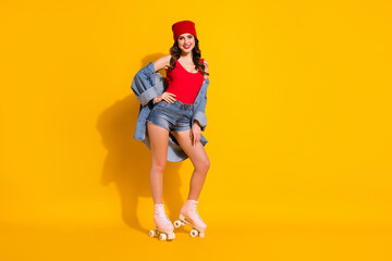 Fototapeta na wymiar Full length photo positive charming girlish youth teen student girl roller skater ready win sporty competition put hands waist wear red headwear tank-top denim isolated bright color background