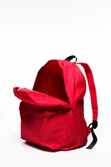 Open red school backpack on white background 
