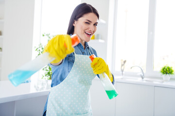 Portrait of her she nice attractive cheerful cheery funny funky housewife cleansing using spray sanitizing having fun fighting dust in modern light white interior kitchen house