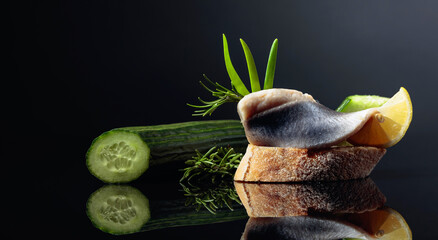 Herring with lemon, green cucumber, onion and rosemary.