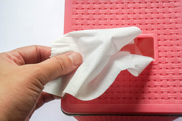 close up people pull tissue sheet from the pink box for cleaning