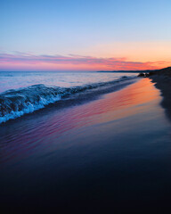 Colorful Blue Hour of the Sunrise Reflecting on the Wet Beach as the Fresh Blue Waves Crash