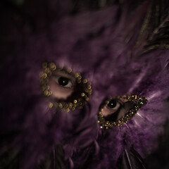 Feather purple theater mask on a performing art actor