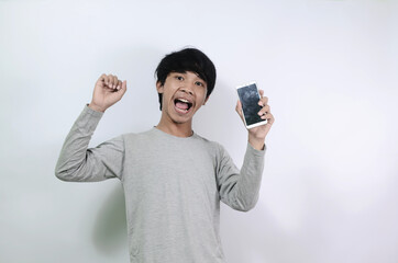 Asian young man who is happy with a smartphone in his hand
