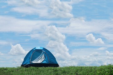 Traveler tent no the mountain with blue sky background.