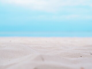 Fototapeta na wymiar Clear white sand and blue sky background.
