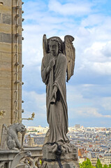 Angel blowing a trumpet on the roof of the Notre Dame Cathedral in Paris, France