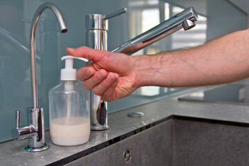 Man washing soapy, men's hands with running water