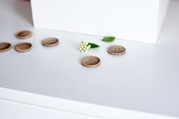 wooden buttons on a white chest of drawers