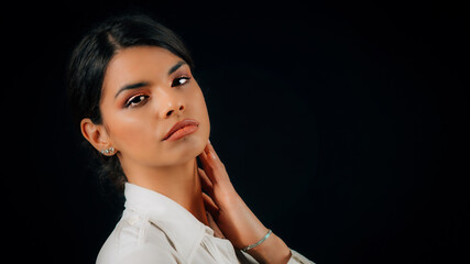 Jealousy - Portrait of a jealous young woman with suspicious in someone or something, studio portrait, black background.