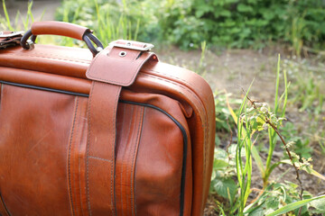 Old suitcase on the background of nature