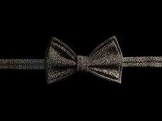 Men's bow tie, on a black background. Accessory for men's clothing.