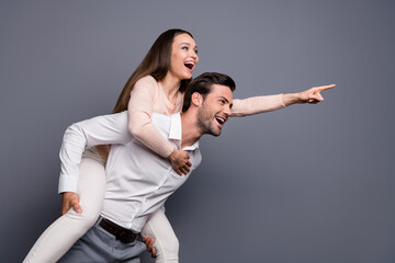 Profile photo beautiful lady handsome guy couple carry piggyback good mood show watch sightseeing travelers direct finger historic building wear shirts pants isolated grey color background