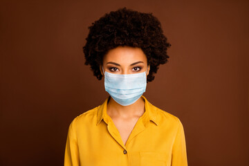 Close-up portrait of her she pretty dark skin wavy-haired lady wearing yellow shirt blouse gauze mask concept sickness illness disease life sars cov ncov prevention isolated on brown color background