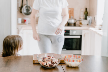 mother and daughter baking in the kitchen