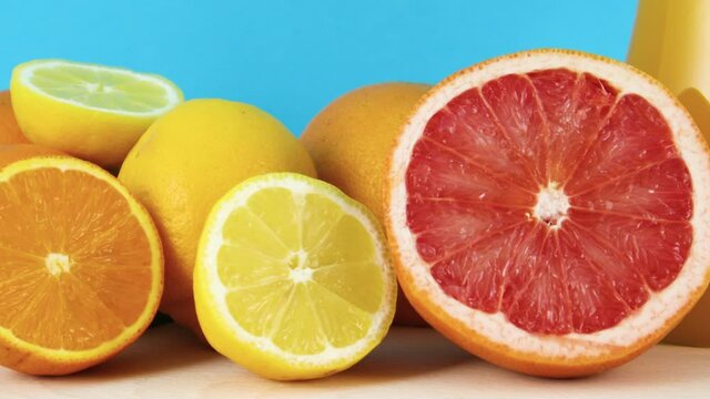 Close up of sliced grapefruit, lemon and orange on blue background 