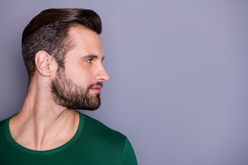 Closeup profile photo of macho attractive guy perfect appearance neat hairdo groomed bristle look side empty space wear casual green t-shirt isolated grey color background