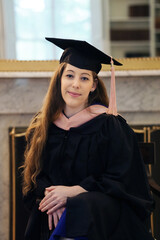 young female graduate in graduation gown