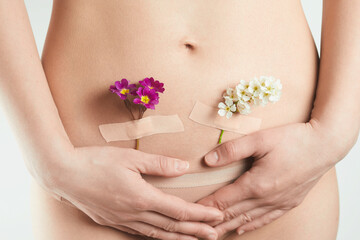 health of female reproductive system. A beautiful woman with flowers on her skin. Pregnancy and Gynecology concept