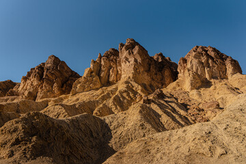 Golden Canyon in Death Valley National Park in the USA. Textured rocky golden peaks in Golden Canyon California 