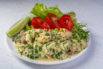 omelet on a plate with tomatoes, cucumber and lettuce