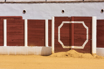 barrier in a bullring with sand
