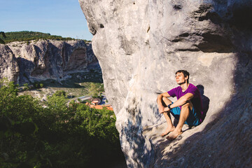 Man sitting on a rock.