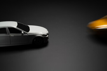 Fototapeta na wymiar ACCIDENT: Toy model car fast comes to standing white toy car