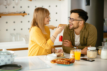 Young couple making breakfast at home. Boyfriend and girlfriend enjoying in morning..	
