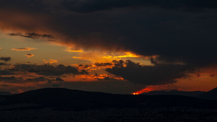 Sunset in Athens with many clouds