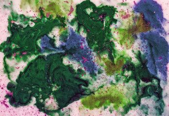 Ink flowing and mixing with colored powder in milk